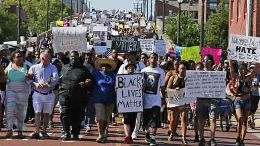 FILE - In this Sunday, July 10, 2016 file photo, people march in a Black Lives Matter rally in Oklahoma City. Black Lives Matter has quietly established a legal partnership with a California charity in a sign of the movement's growth and expanding ambition. The Associated Press has learned that IDEX is managing the group's financial affairs, allowing Black Lives Matter to focus on its mission, including building local chapters and experimenting with its organizational structure. (AP Photo/Sue Ogrocki, File)
