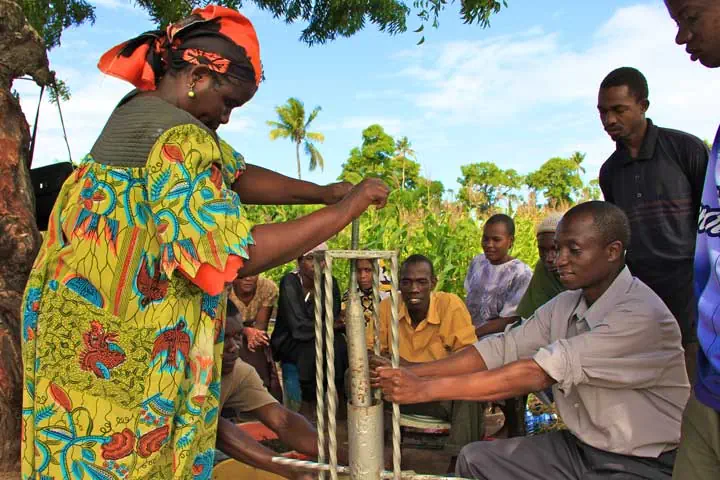“Woman at new water pump.” Community Project, Foundation for Sustainable Development. Photo Courtesy of: FSD.