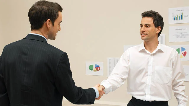 "Businessmen shaking hands" by reynermedia licensed under CC BY 2.0