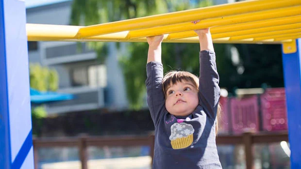 "Kid playing in the monkey bars" Photo courtesy of Holy Family Day Home