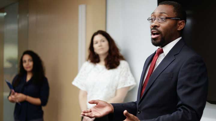 "Policy and Advocacy Manager speaks during the United States Conference on Aids" Photo Courtesy of:  National Minority AIDS Council